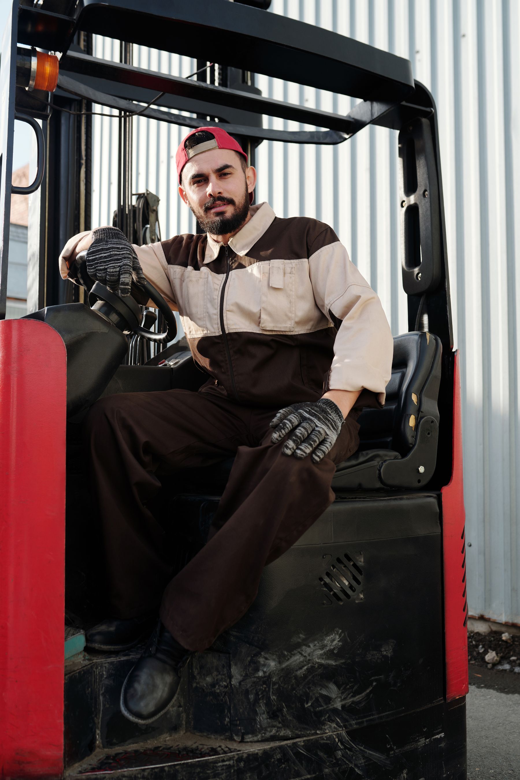 Forklift operator seated at the controls in a warehouse